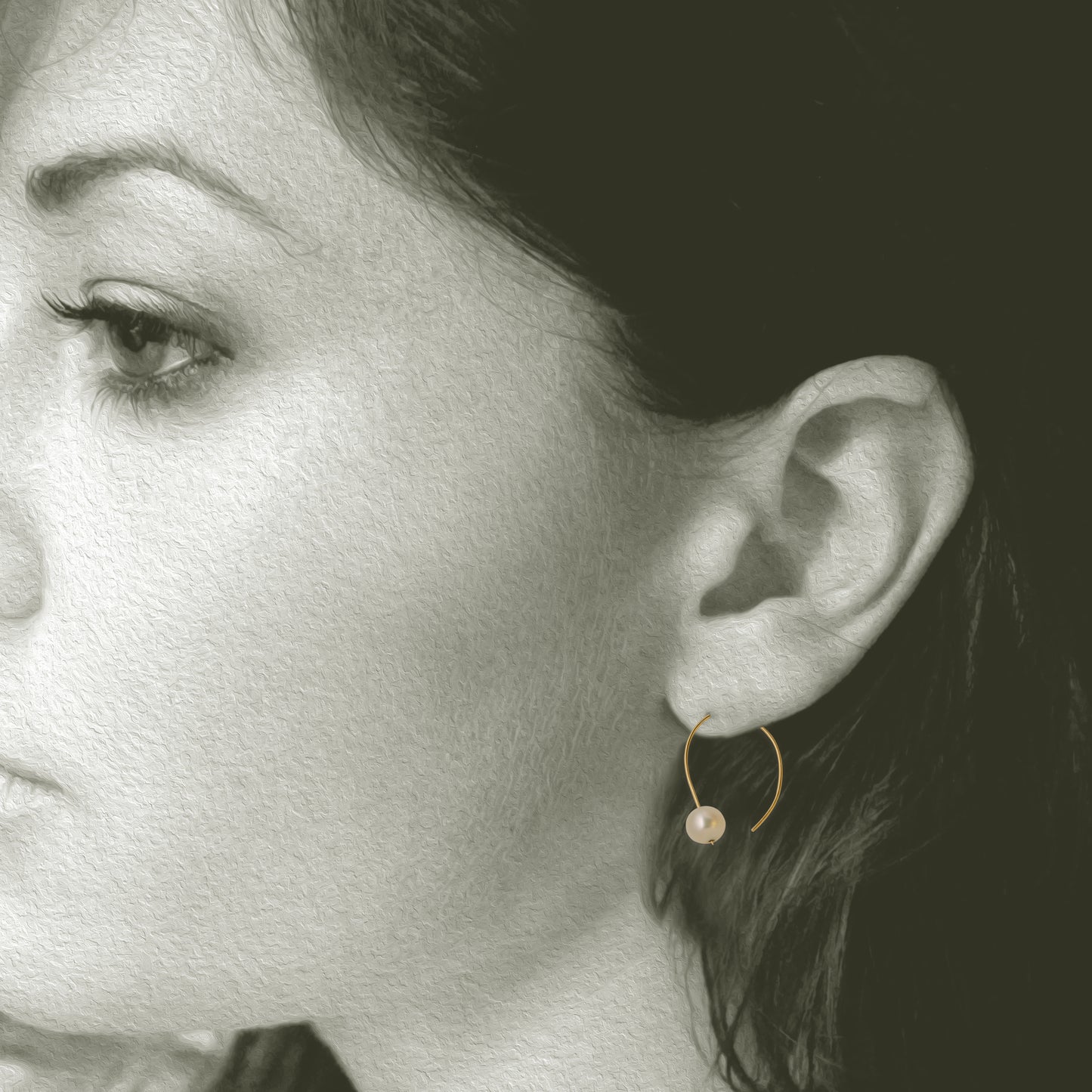 Simple 18kt and pearl open hoop earring. 7mm round pearls 1 on each hoop earring 1.25" x .5". Shown on model.