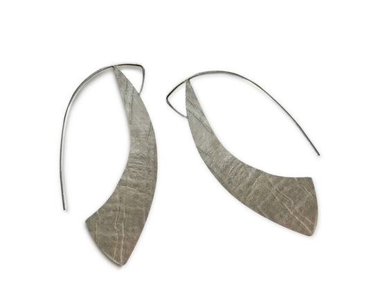 Our Sterling Silver Silhouette Hoop Earrings are a contemporary take on a classic look. Hand crafted in recycled sterling silver, these lightweight and comfortable earrings offer a beautiful snapshot of your personal style.
A must-have for everyday wear, their 1.5" long x 1" wide size ensures they stay perfectly in place, framing your face with effortless elegance. Allow 2-4 weeks for delivery, but if you have to have them sooner, please contact the studio and we will see if we can accommodate you.