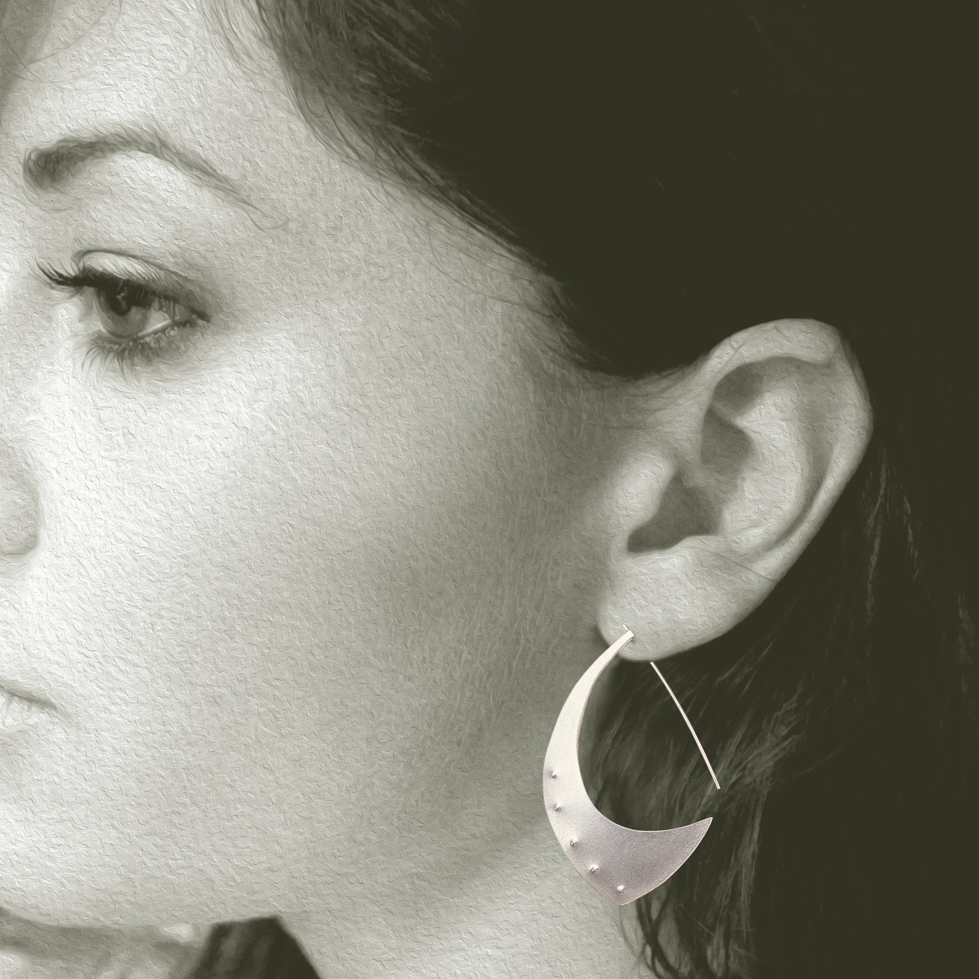 The Aubergine Sterling Silver Hoop Earrings are the perfect size. When you put them on, the only time you will notice them is when you look in the mirror, because they are surprisingly lightweight. Fabricated from recycled sterling silver.  FEATURES  º Hand fabricated in recycled sterling silver  º Soft brushed cashmere finish  º 2" total length. Shown on a model.