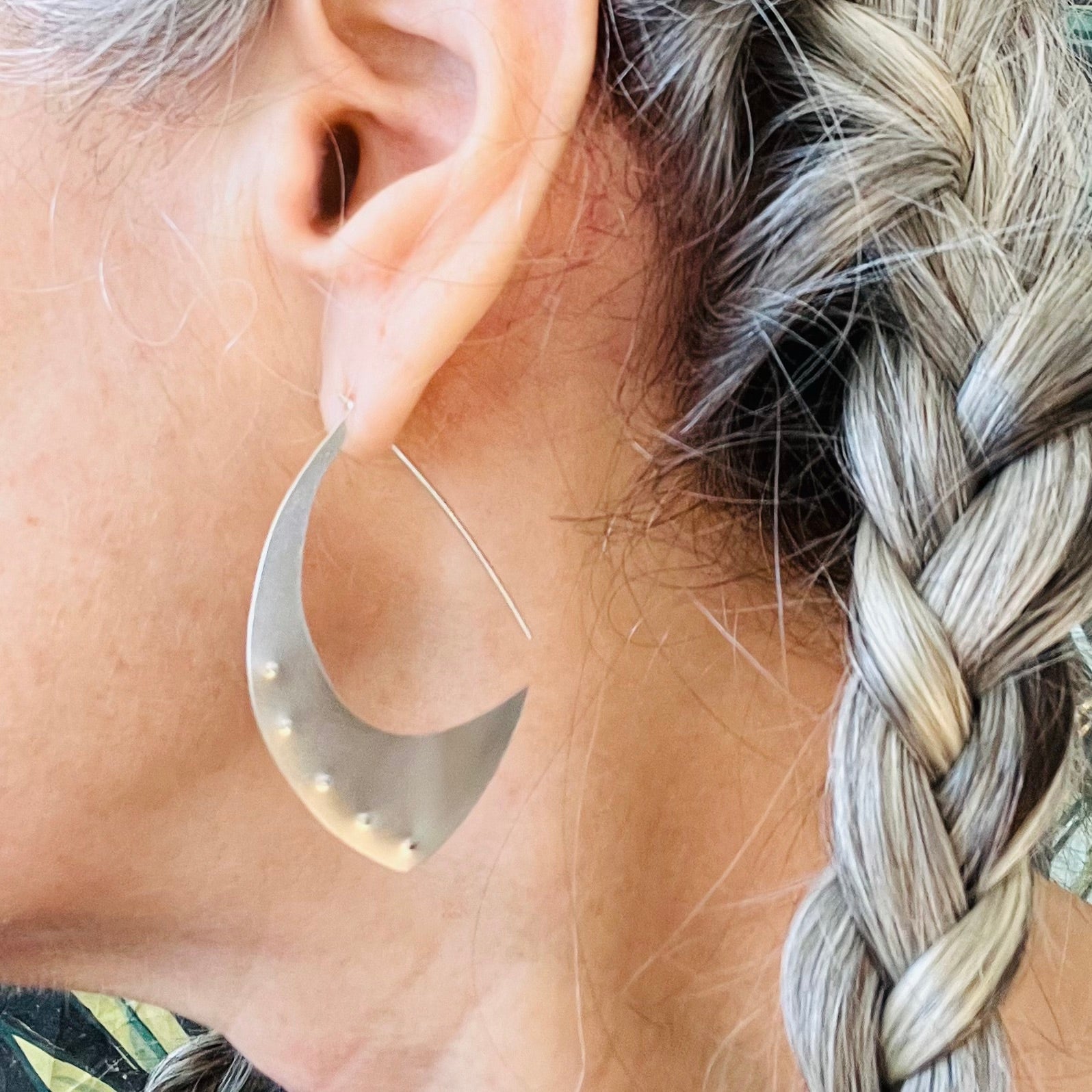 The Aubergine Sterling Silver Hoop Earrings are the perfect size. When you put them on, the only time you will notice them is when you look in the mirror, because they are surprisingly lightweight. Fabricated from recycled sterling silver. FEATURES º Hand fabricated in recycled sterling silver º Soft brushed cashmere finish º 2" total length. Shown on a model.
