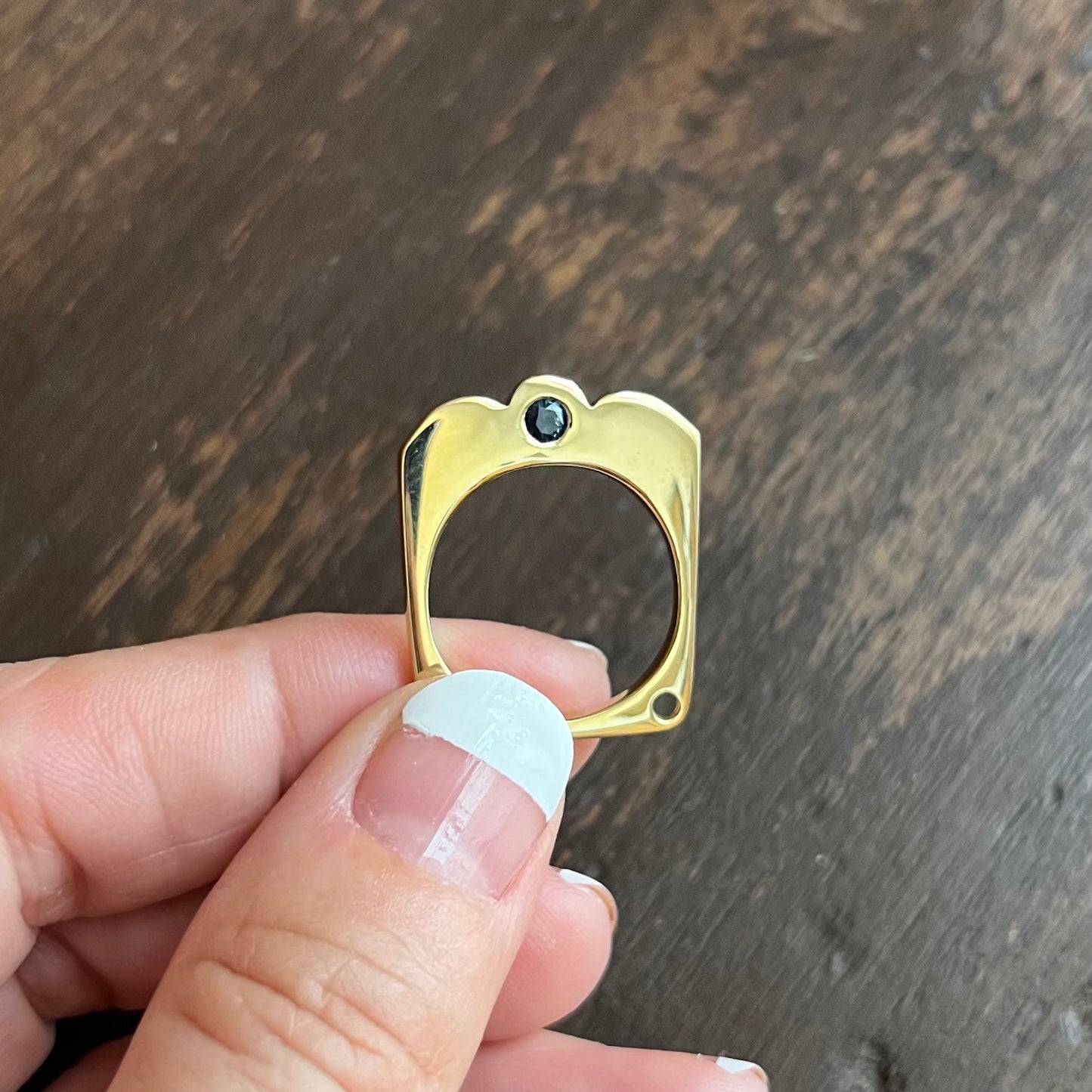The gemstone in the Cloud Flat Ring is set through instead of on top – so it catches the light and your eye when you move your hands. FEATURES: º Hand-carved and cast in 14kt recycled gold. º 1 flush set blue sapphire º Comfortable inside fit º Cashmere finish. º Available to ship in a size 7.