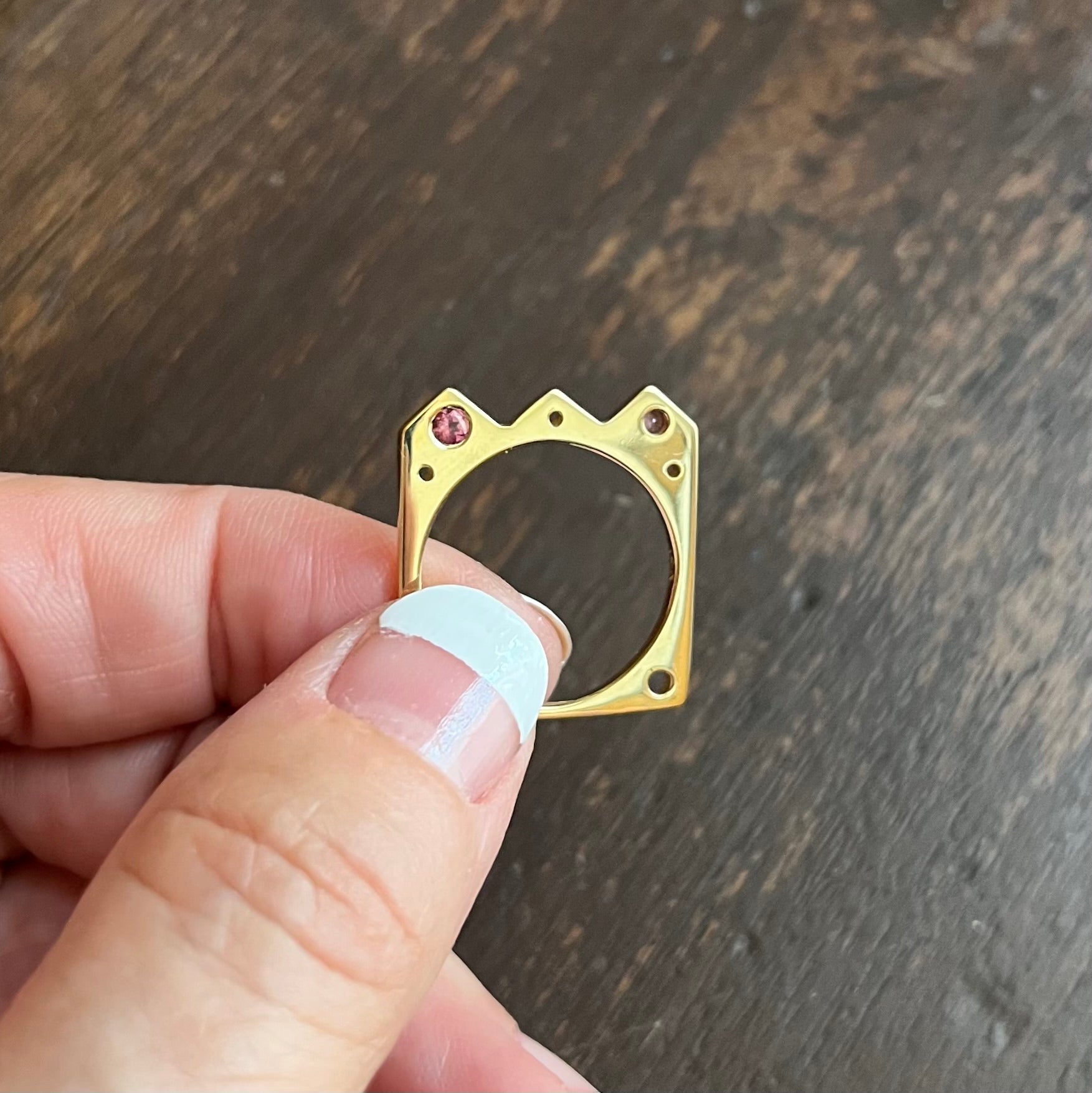 The Crown shaped Flat Ring: º Wear alone or stacked with your favorite stacking bands  º Hand-carved and cast in 14kt recycled gold.   º 2 flush set dark pink tourmalines  º Comfortable inside fit  º Cashmere finish.  º Available to ship in a size 7.