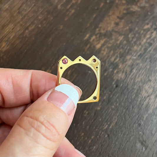 The Crown shaped Flat Ring: º Wear alone or stacked with your favorite stacking bands  º Hand-carved and cast in 14kt recycled gold.   º 2 flush set dark pink tourmalines  º Comfortable inside fit  º Cashmere finish.  º Available to ship in a size 7.