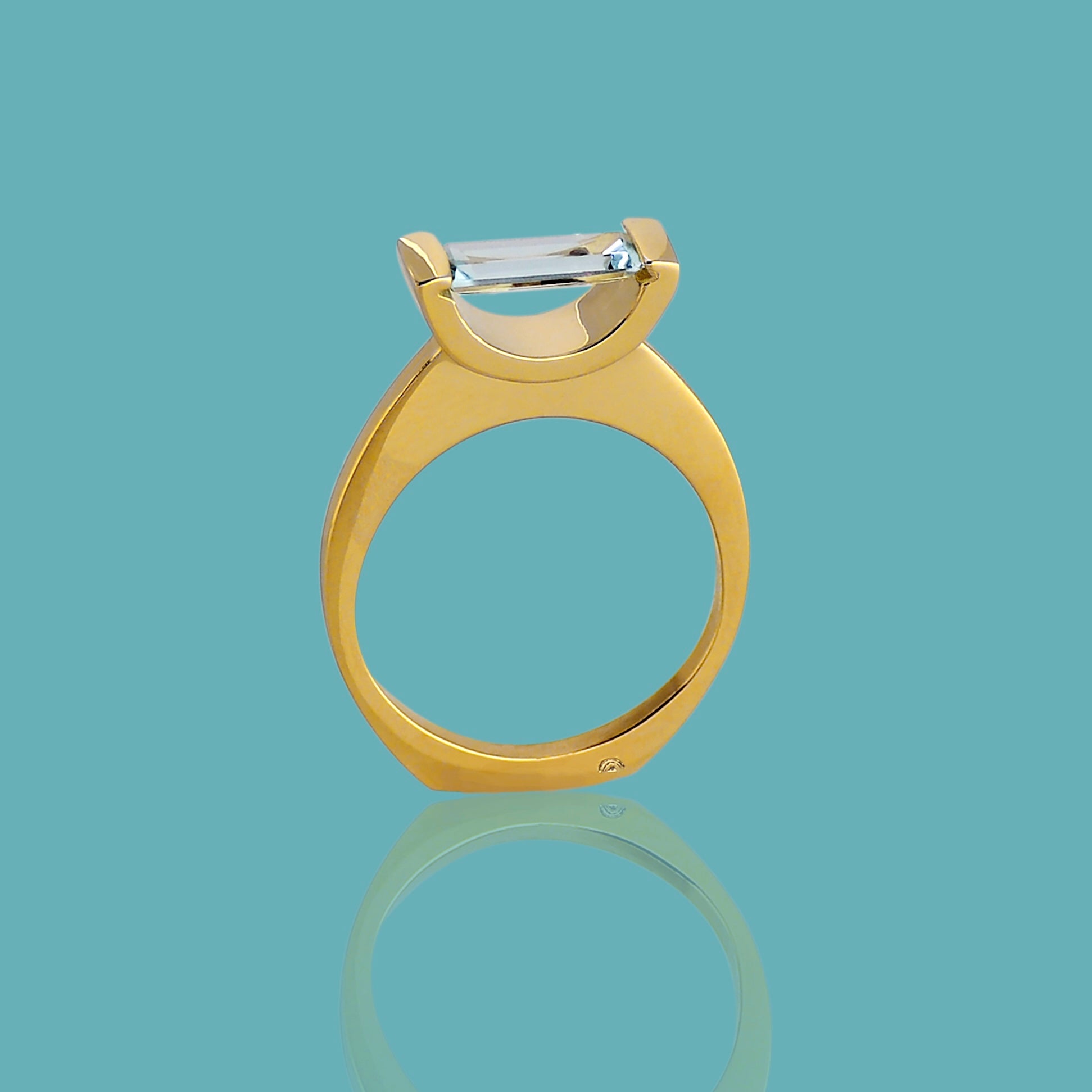 18kt Fairmined yellow gold hand made ring with a baguette cut Aquamarine set horizontally, almost like it is suspended in space. Size 7