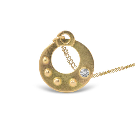 The Circle Shield Motif that you wear over your heart helps you visualize your inner strength that gives you your personal power.
Hand Fabricated in 18kt recycled yellow gold and a round white 3.5mm reclaimed diamond, the CIRCLE SHIELD Pendant encourages us to savor the important moments and gently reminds us that we own our power, no one else.
The Circle Shield Pendant is handcrafted in Minnesota from 18kt yellow gold recycled in studio forged from retired jewelry.  