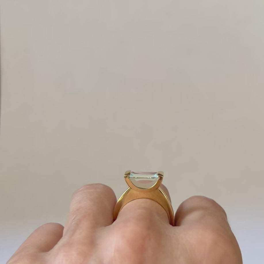 18kt Fairmined yellow gold hand made ring with a baguette cut Aquamarine set horizontally, almost like it is suspended in space. Size 7