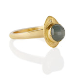 Our Blue-Sorbet Sapphire and Gold Ring is a blend of sculptural and textural elements.   º One-of-a-kind  º Made from  14kt Fairmined yellow gold  º Responsibly Sourced rose-cut 5.5mm round blue sapphire is hand set in a bezel. A 2mm round reclaimed diamond is flush set.  º Soft cashmere brushed finish  º Hand carved and cast in Minnesota  º Available to ship in a size 7.