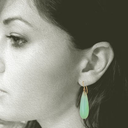 Iridescent Peruvian Opals carved into soft drop earring with recycled 18kt yellow gold ear wires. Designed and made in Minnesota. Opals mined in Peru. Shown on model for scale.