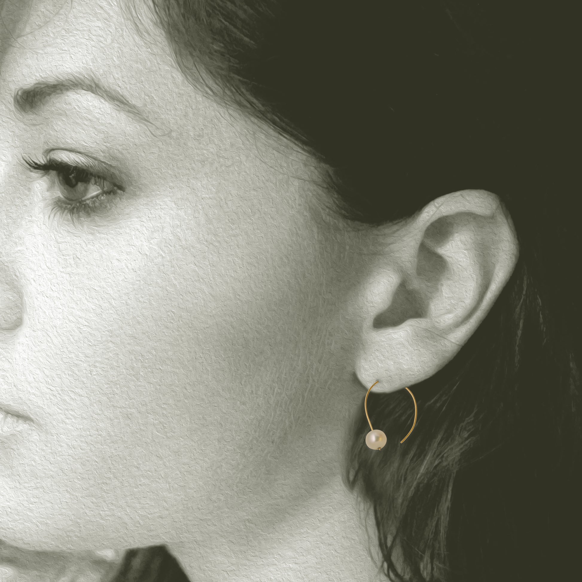 Simple 18kt and pearl open hoop earring. 7mm round pearls 1 on each hoop earring 1.25" x .5". Shown on model.