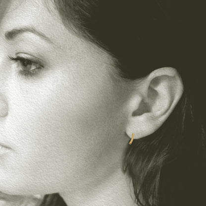 Slight Gold Earrings: Post earrings made in 14kt yellow gold. 3/8" long x 1/8" wide. Shown on Model