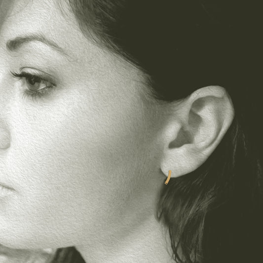 Slight Gold Earrings: Post earrings made in 14kt yellow gold. 3/8" long x 1/8" wide. Shown on Model