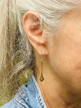 Susan Crow Studio gold drop earrings with .05cwt champagne colored reclaimed diamonds. Elegant profile, lightweight earrings. Shown on a model