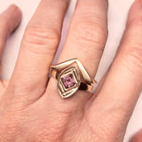 14kt yellow gold ring with a square cut Rhodolite Garnet flush set at a right angle  into the center of the ring. Size 7 Shown on a hand stacked with our Viceroy 14kt yellow gold ring.