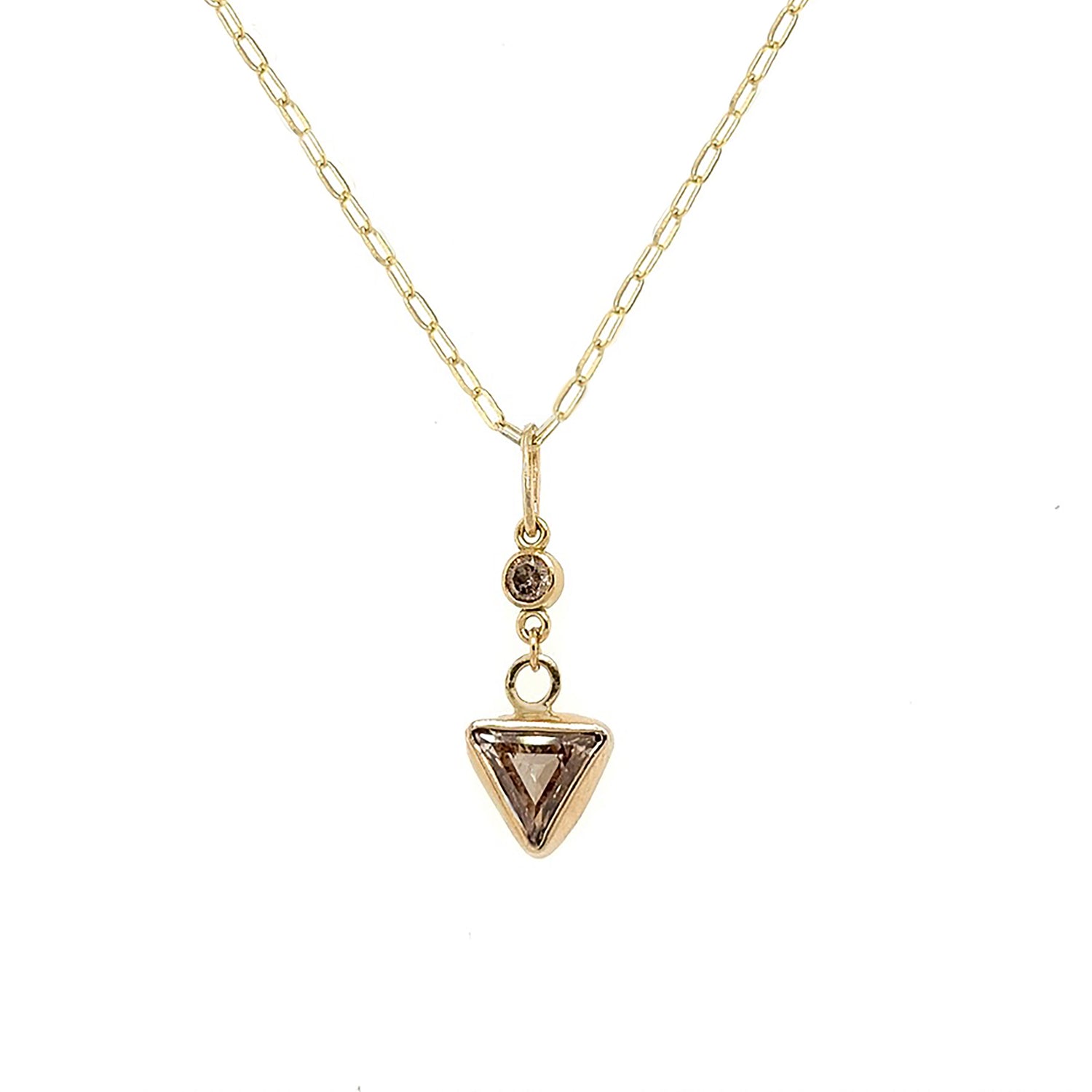 CHAMPAGNE DIAMOND PENDANT 
Warm champagne colored triangular-cut diamond pendant. Highlighted with an additional matching round diamond.
A delicate and classic diamond pendant.

º 5mm triangle-cut repurposed champagne diamond. 

º 3mm round repurposed champagne diamond.

º Setting is handmade from reprocessed 14kt and 18kt yellow gold.

º 18" 14kt yellow gold elongated oval links paper clip chain.

º Ready to ship