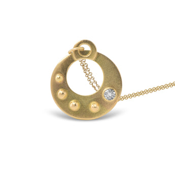 The Circle Shield Motif that you wear over your heart helps you visualize your inner strength that gives you your personal power.

Hand Fabricated in 18kt recycled yellow gold and a round white 3.5mm reclaimed diamond, the CIRCLE SHIELD Pendant encourages us to savor the important moments and gently reminds us that we own our power, no one else.

The Circle Shield Pendant is handcrafted in Minnesota from 18kt yellow gold recycled in studio forged from retired jewelry.  