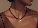 Crafted in 14kt certified recycled rose gold . Creative Direction: Michella Cruz & Jackie Barbosa Photo: Chad Johnson (IG: @commercialartlab) Model: Michella Cruz (IG: @MichellaCruz) Styling: Jackie Barbosa (IG: @World.of.barbosa) Hair and Makeup: Daniel Pazos (IG: @Daniel_the_beauty_beast) 1" round pendant with small holes as the design. In some holes there are small diamonds flush set. Made of 18kt Fairmined yellow gold, and it is on a 17" multi strand leather neck cord with an 18kt yellow gold clasp.