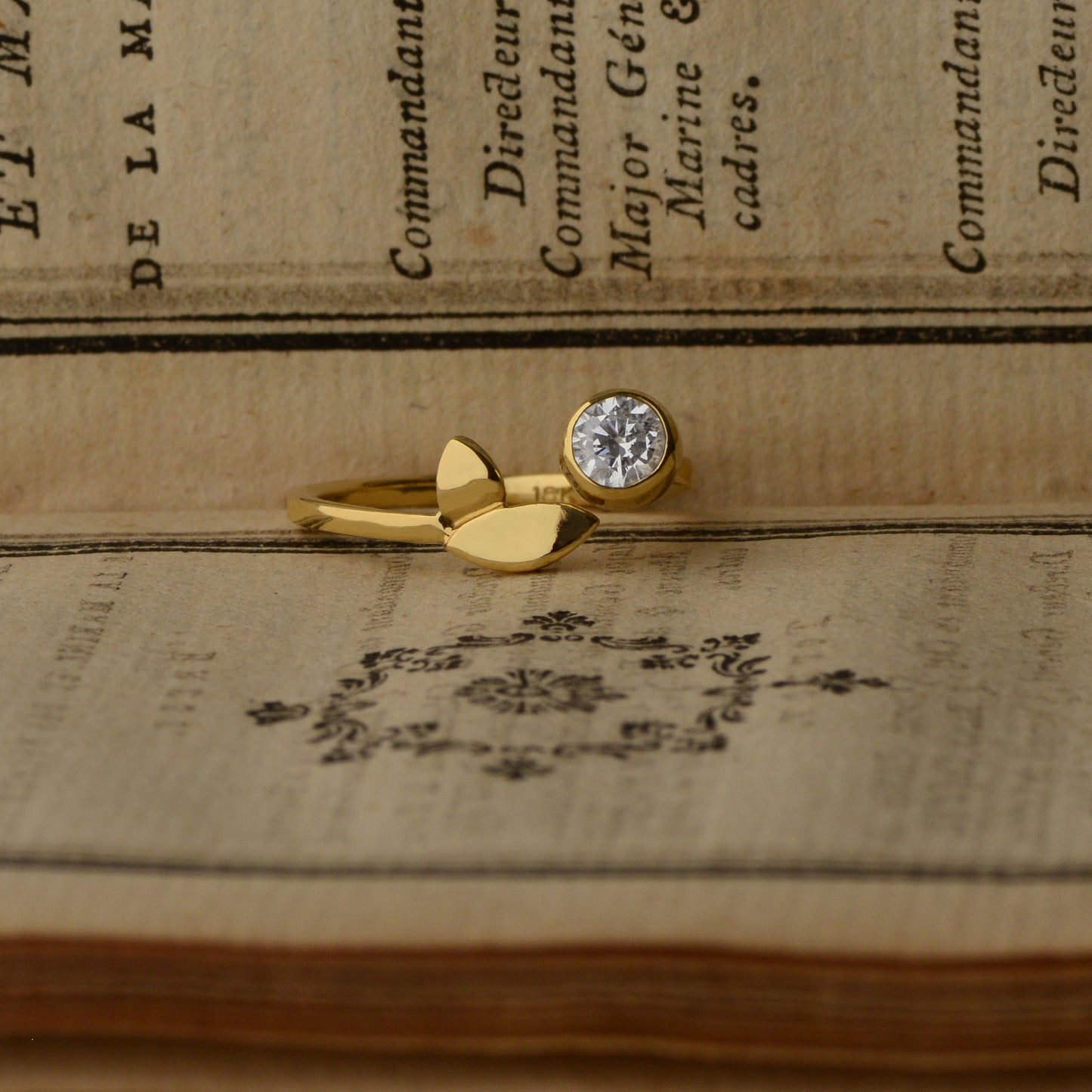 Flora Leaf diamond ring in 18kt yellow gold styled with book, alternative engagement ring"