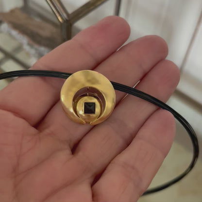 The Moon Pendant has a 4mm genuine square cut Black Spinel gemstone and the multiple circle dome shaped pieces make up the pendant . it is approximately 1" in diameter and hangs from a 17” multi strand black ruthenium plated sterling silver collar with a 14kt gold barrel clasp.