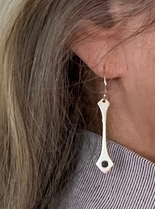 Our Blue Sapphire and Sterling Silver Earrings are inspired by the textures of grass blowing on the edge of a beach sand dune.   Features  º Modern drop earrings are handmade  º Made from recycled sterling silver  º Reclaimed 2.8mm round genuine blue sapphires  º 1 1/2" total length  º Soft brushed finish