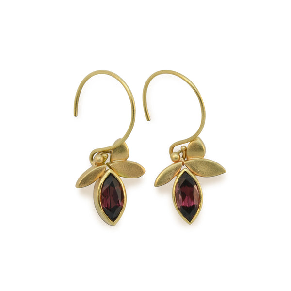 14kt yellow gold earrings with a 3 leaf design have 2 bezel set,  5mm x 7mm marquise cut responsibly sourced dark red Rhodolite Garnets. Earrings are 1.25
