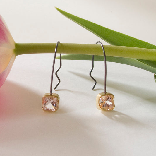 Part of our silver collection, these genuine Morganite Hoop Earrings offer an alternative artistic impression. Pink sparkling Morganite gemstones bezel set in 18kt yellow gold with sterling silver hoops.