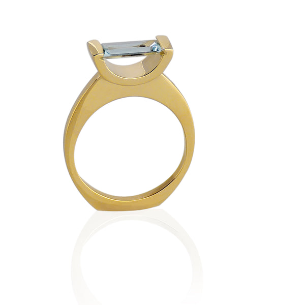 18kt Fairmined yellow gold hand made ring with a baguette cut Aquamarine set horizontally, almost like it is suspended in space. Size 7