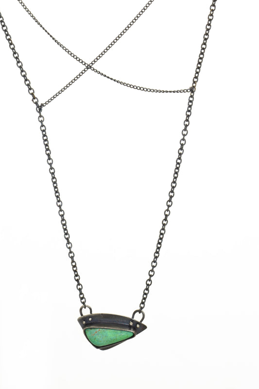 triangular shaped blue-green turquoise that is bezel set into a handmade one of a kind oxidized sterling silver pendant.  total chain length is 22" total pendant size is 1" x 1/2"  Turquoise was mined and cut in Nevada. Sterling silver is recycled.