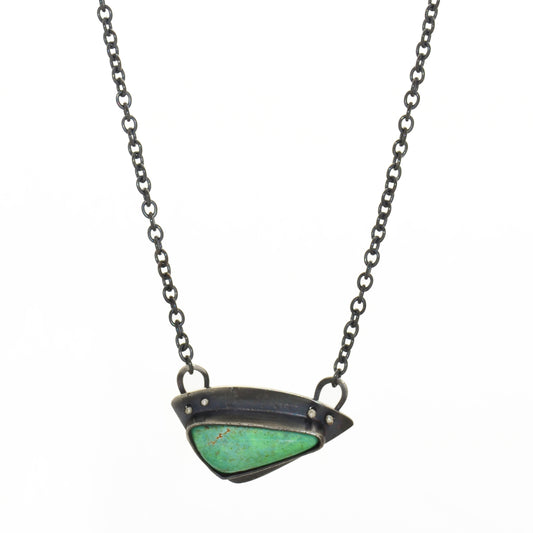 triangular shaped blue-green turquoise that is bezel set into a handmade one of a kind oxidized sterling silver pendant.  total chain length is 22" total pendant size is 1" x 1/2"  Turquoise was mined and cut in Nevada. Sterling silver is recycled.