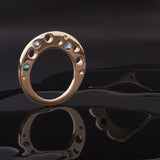 Circle Shaped Flat Ring º Unusually comfortable worn as a thumb ring or on your middle finger  º Hand-carved and cast in 14kt recycled gold.   º 3 flush set aquamarines  º Comfortable inside fit  º Cashmere finish.  º Available to ship in a size 7. 